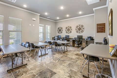 Business center with computer stations and tables at Riverview Apartments, Chalmette, LA
