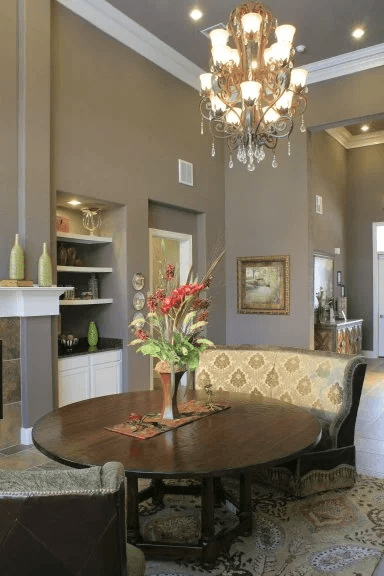 Elegant dining room with chandelier and round table at Riverview Apartments, Chalmette, Louisiana