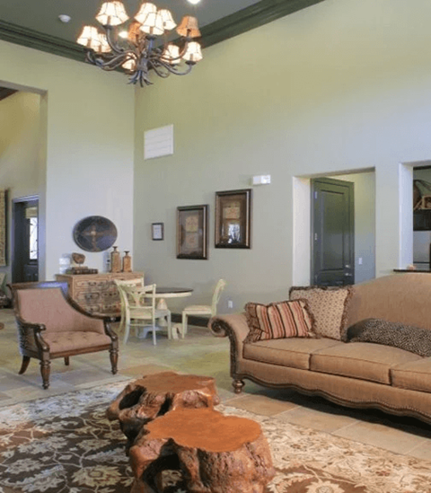 A living room with a brown couch and a wooden coffee table.