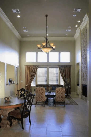A dining room with a table set for four.