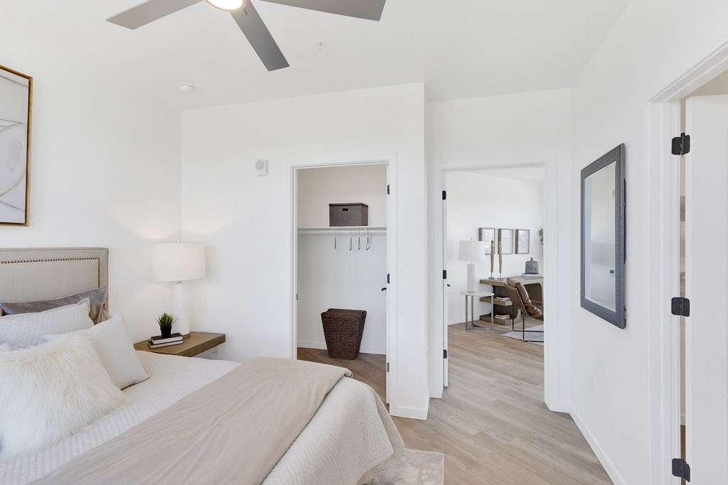 a bedroom with a bed and a ceiling fan