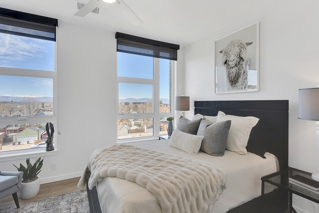 a bedroom with a large bed and a large window