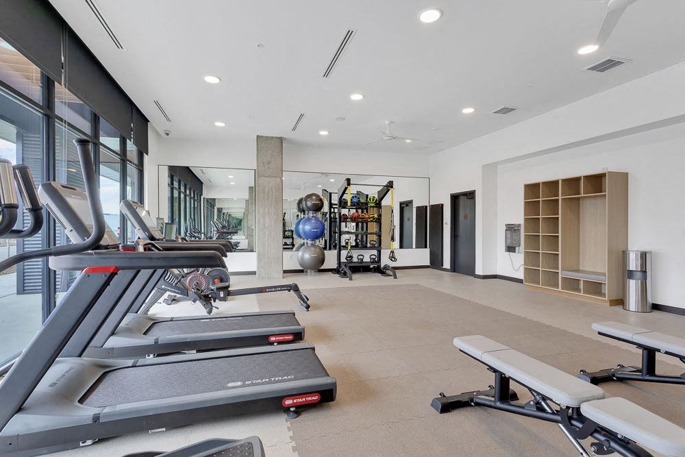 a gym with treadmills and other exercise equipment