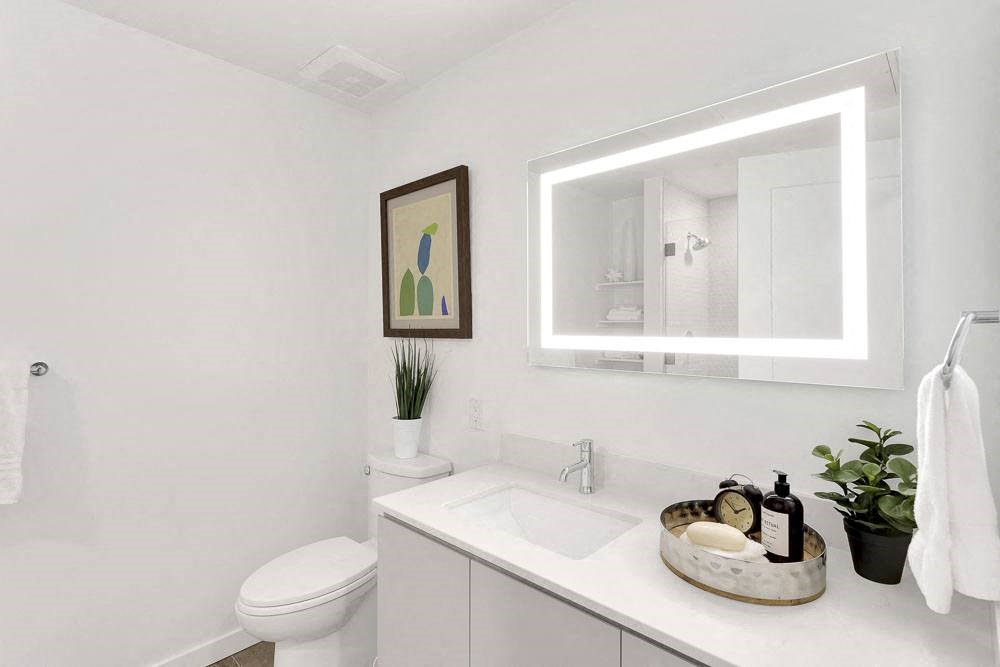 a bathroom with a sink toilet and mirror