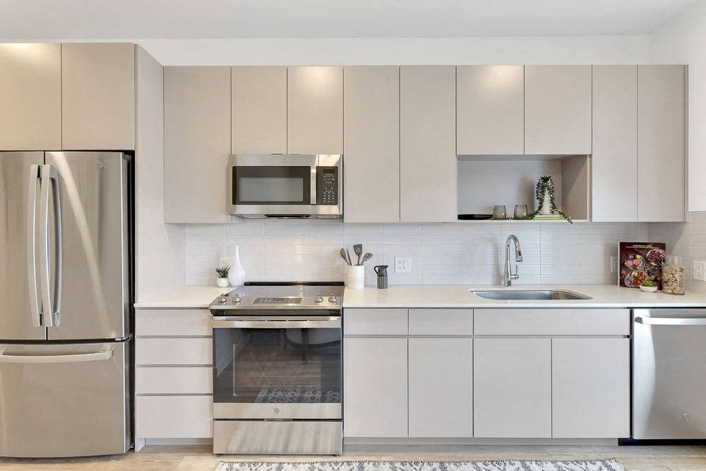 a kitchen with a stove top oven next to a refrigerator