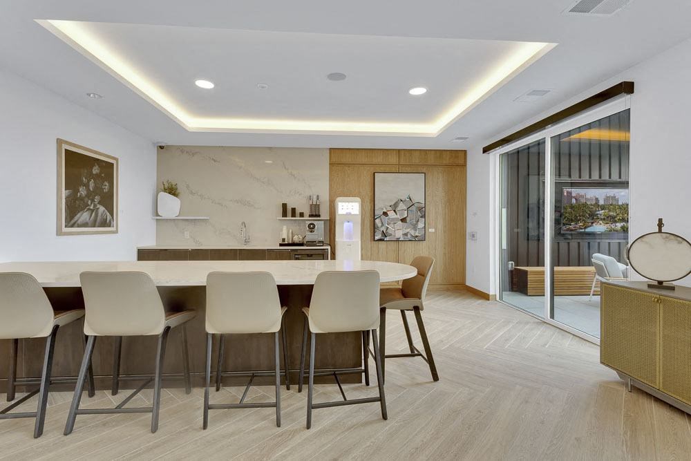 a room with a table and chairs and a counter