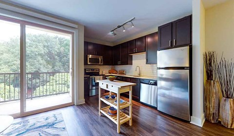 a kitchen with stainless steel appliances and a sliding glass door