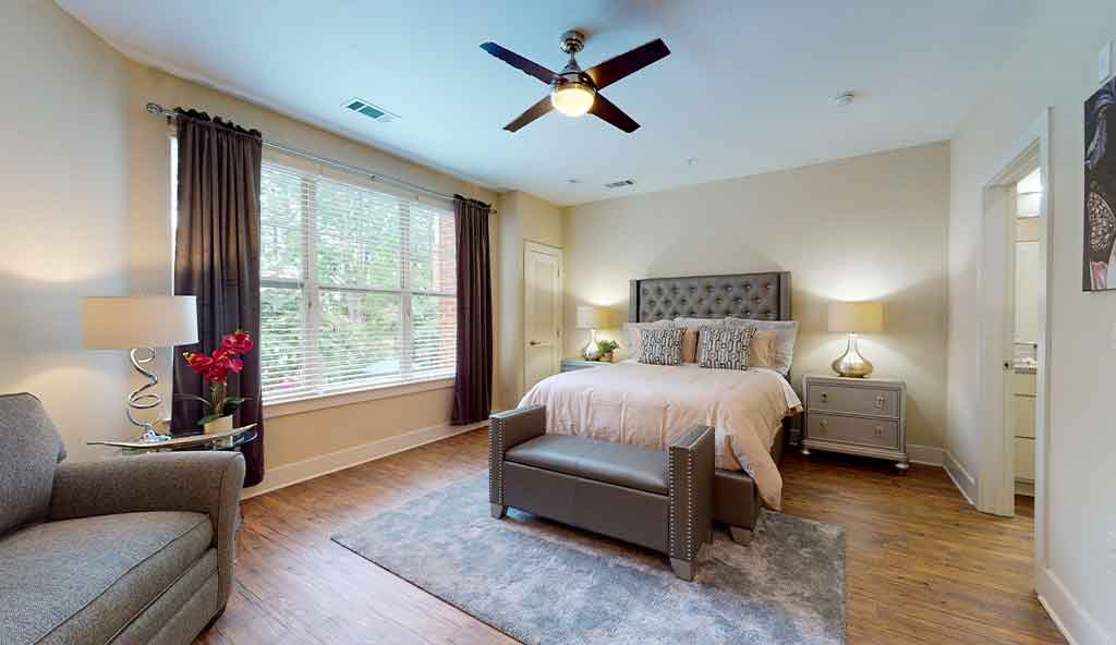 a bedroom with a bed and a ceiling fan