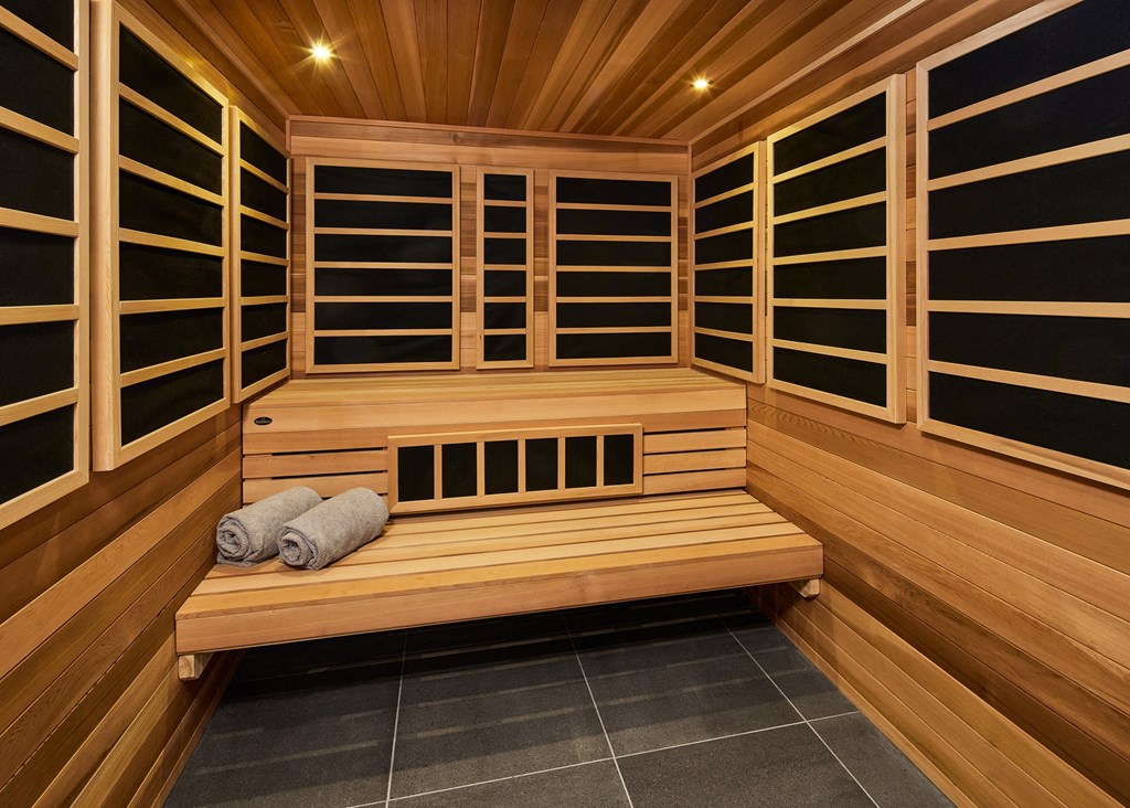 a dryer in a wooden sauna with rolled up towels