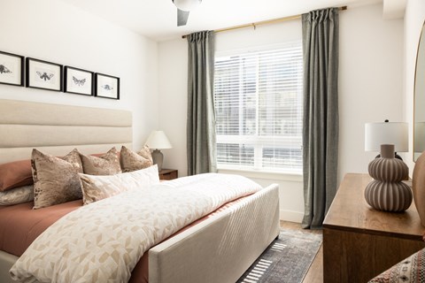 a bedroom with a bed and a large window