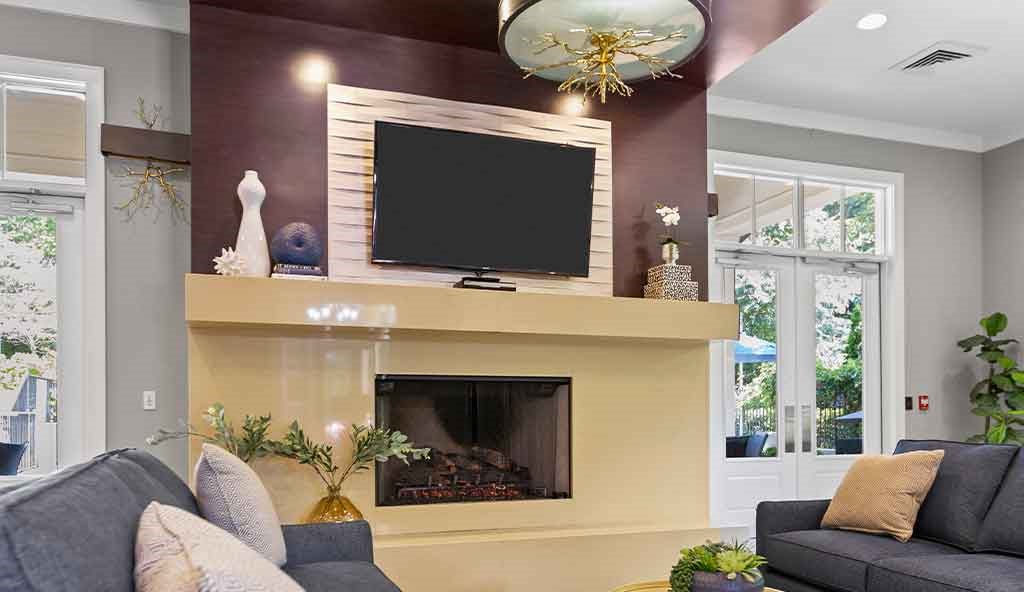 a living room with a fireplace and a tv on the wall