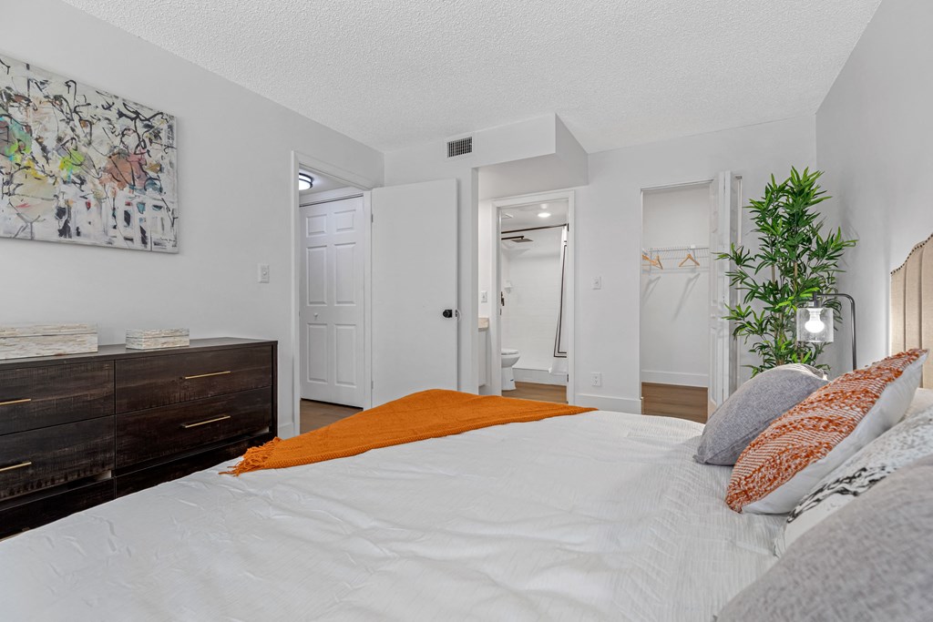 a bedroom with a large bed and a dresser