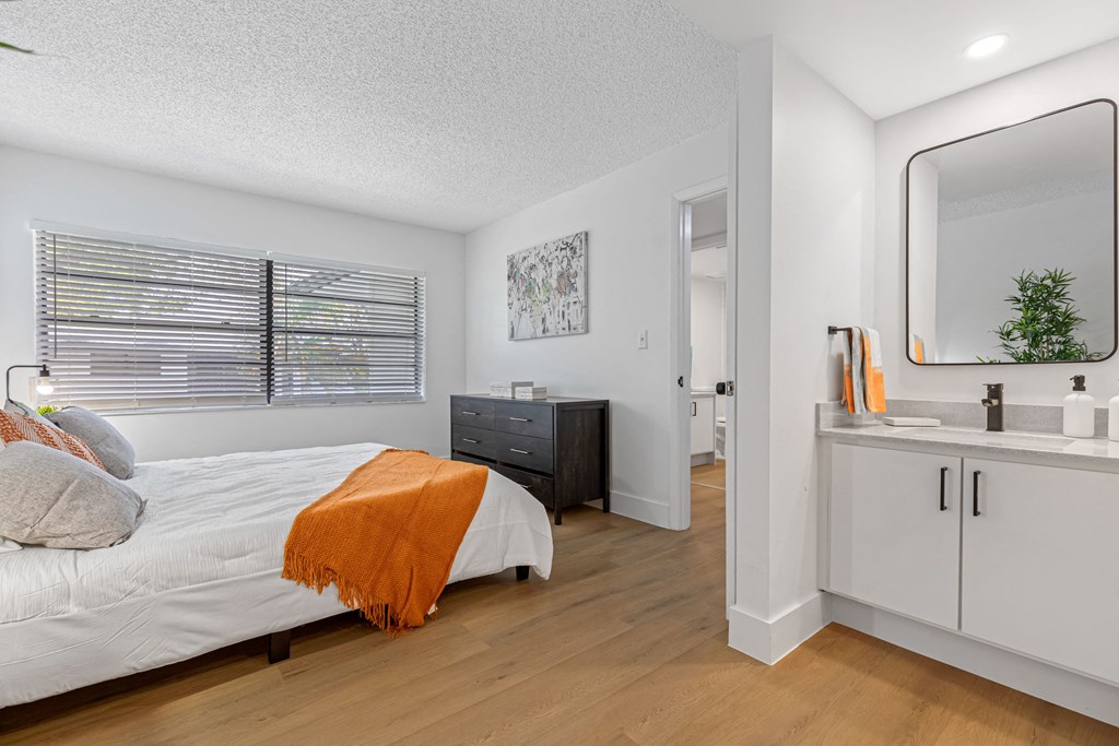 a bedroom with a bed and a mirror