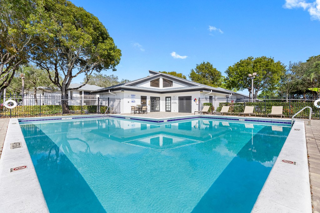 a pool with a house in the background