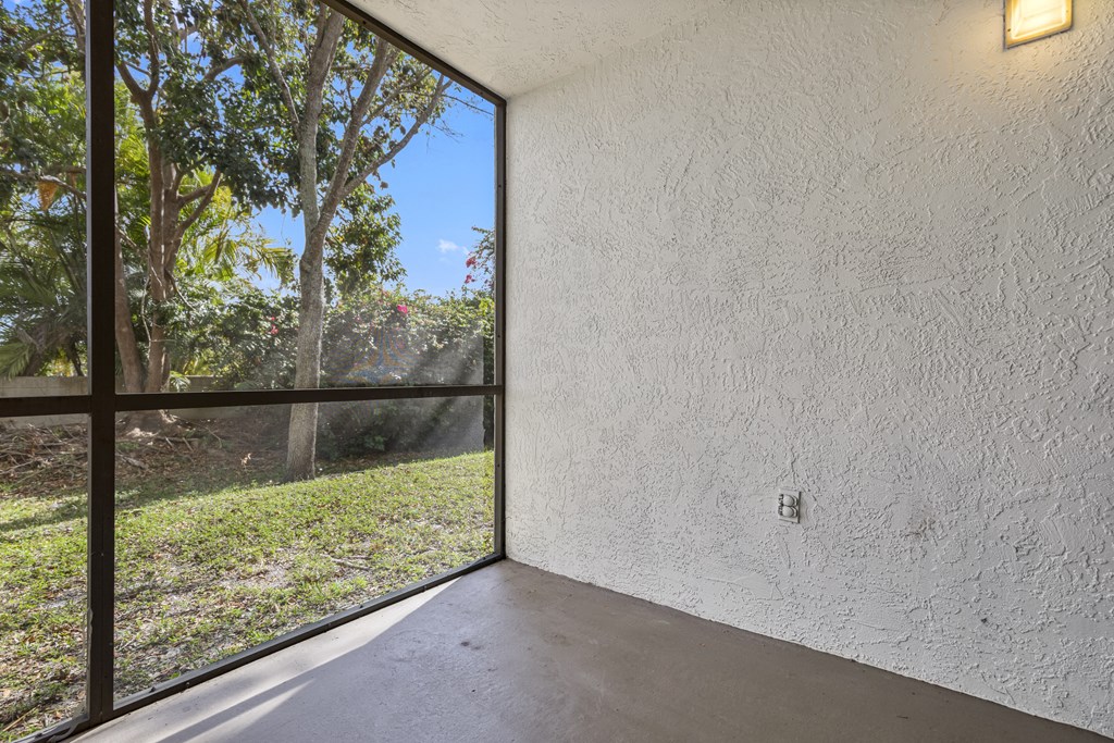a large window in a room with a concrete floor