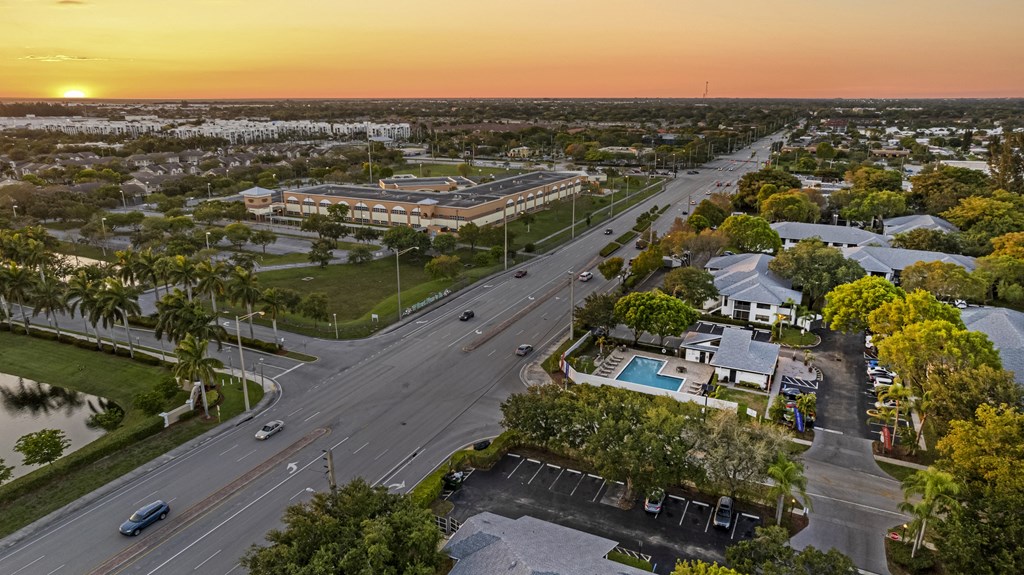 an aerial view of a city with a sunset in the background