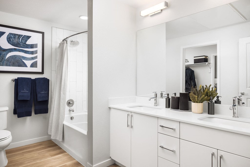 A bathroom with a white toilet, a white sink, and a white bathtub.