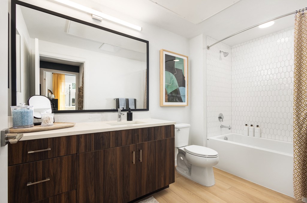 a bathroom with a toilet and a sink and a mirror