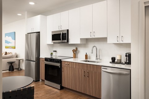A modern kitchen with wooden cabinets and stainless steel appliances.