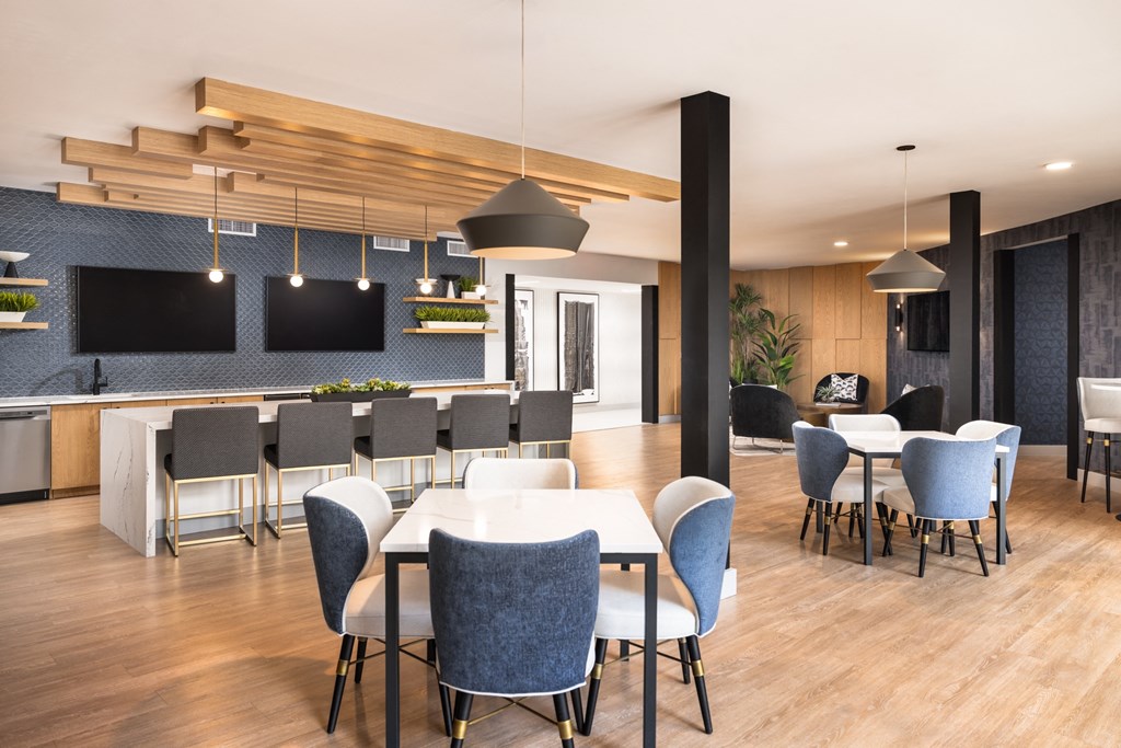 A modern dining room with a long table and chairs.
