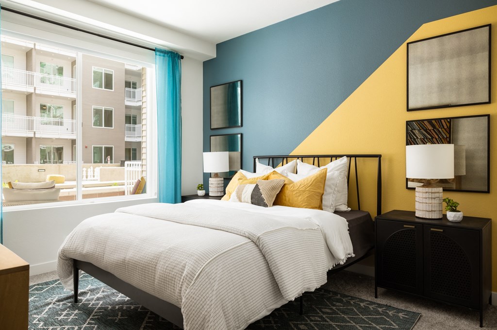 a bedroom with a bed and a large window