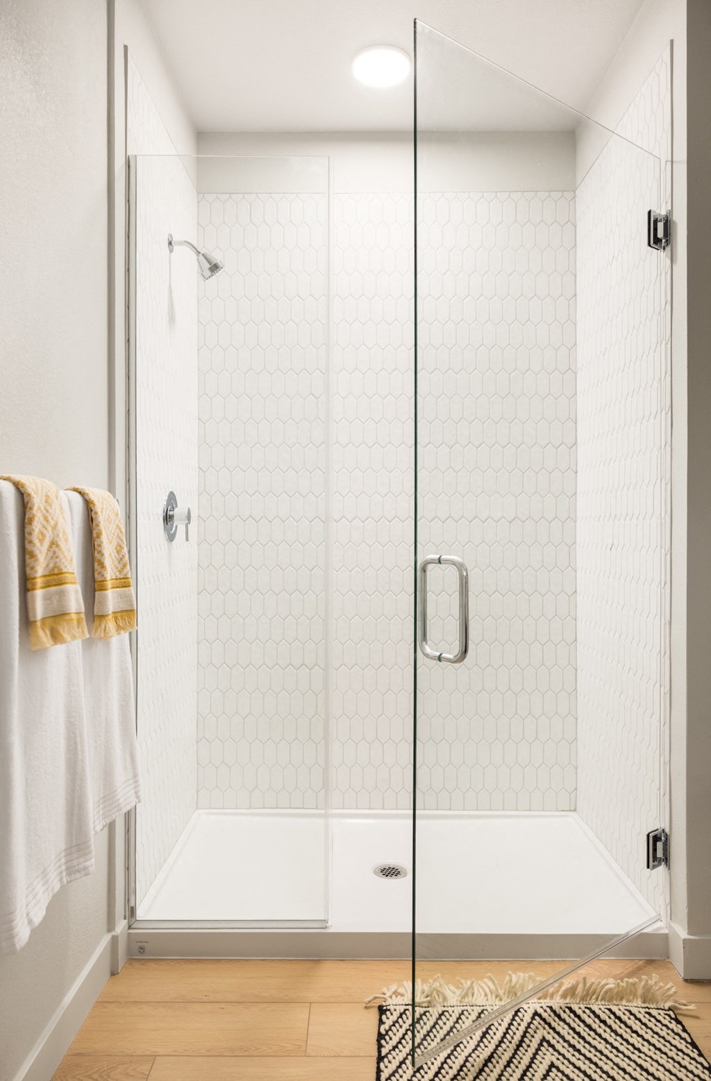 a bathroom with a shower with a glass door