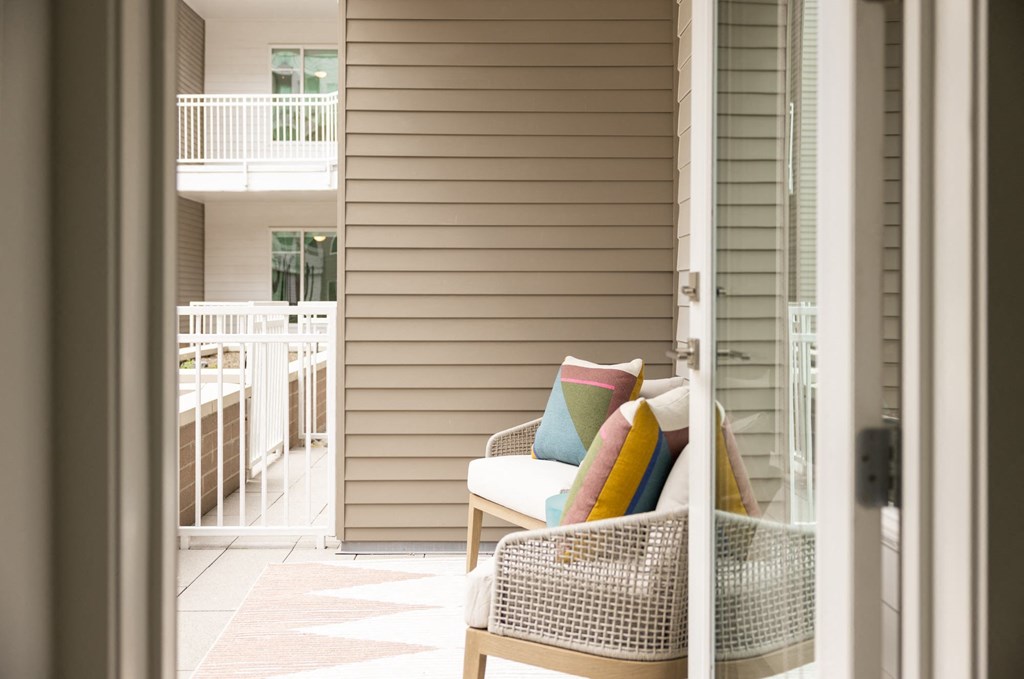a view of a porch with a chair and a balcony