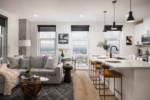 A modern living room with a grey couch and a coffee table.
