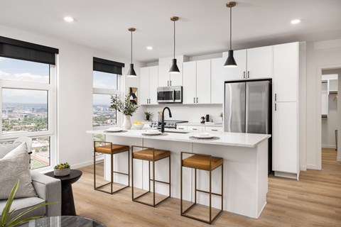 A modern kitchen with white cabinets and a large island.