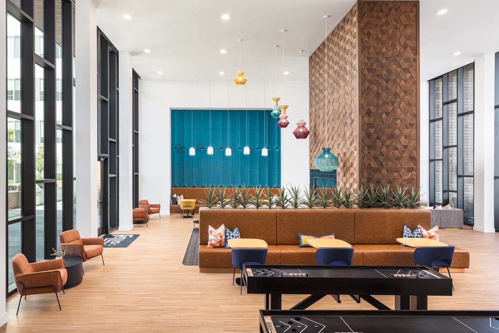 a lobby with couches and chairs and a large blue door