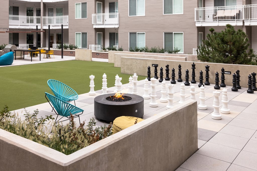 A chess set is set up on a patio.