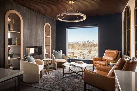 a living room with couches chairs and a table and a window