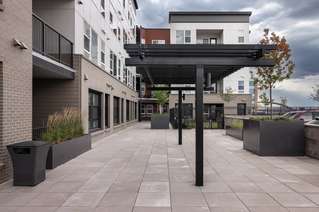 A modern building with a walkway and planters.