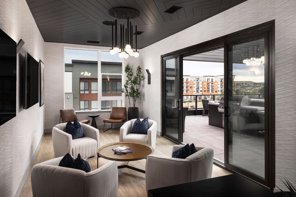 A modern living room with a large window and a view of the city.