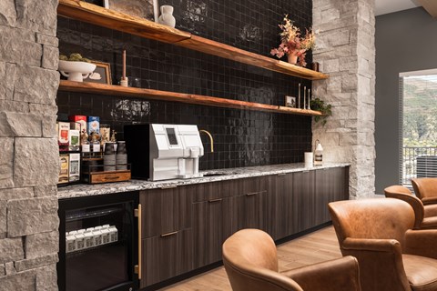 A modern kitchen with a stone wall and wooden shelves.