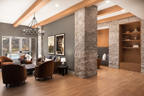 A living room with a stone pillar and wooden floors.