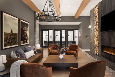 A modern living room with a brown sofa, a coffee table, and a fireplace.