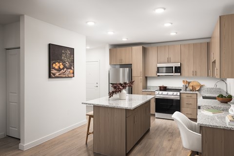 A modern kitchen with wooden cabinets and a central island.