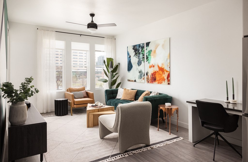 a living room with white walls and a green couch