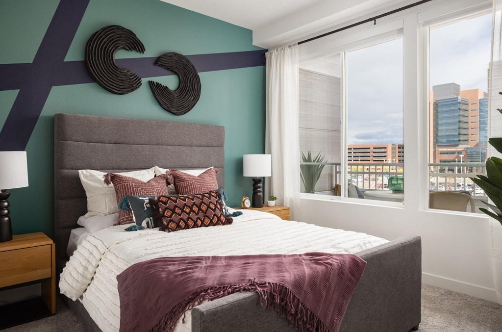 a bedroom with a bed and a large window