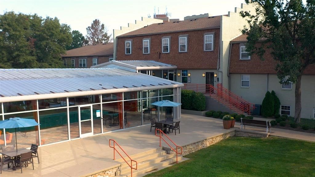 a large building with a swimming pool in front of it