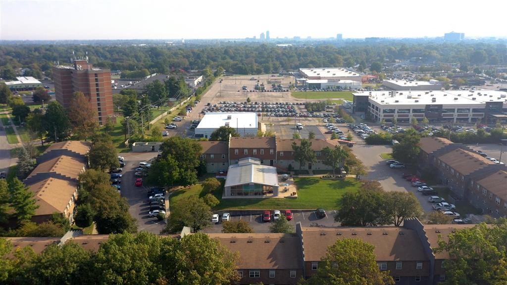 an aerial view of a city with a parking lot and buildings