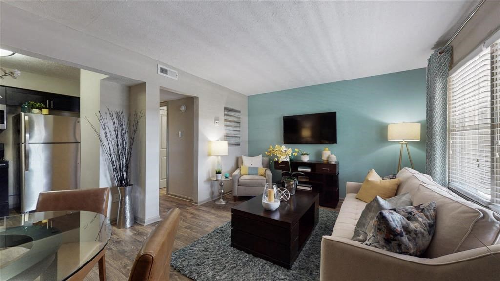 a living room filled with furniture and a flat screen tv