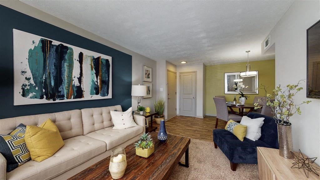 a living room with a couch a table and a chair