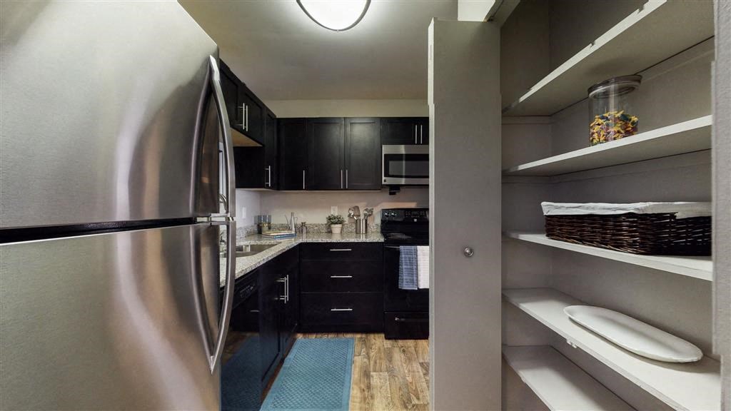 a kitchen with a stainless steel refrigerator freezer next to a sink