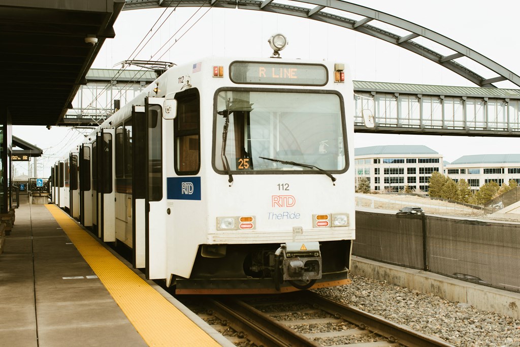 a white train pulling into a train station