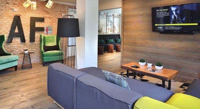 a living room with a couch and a tv on the wall