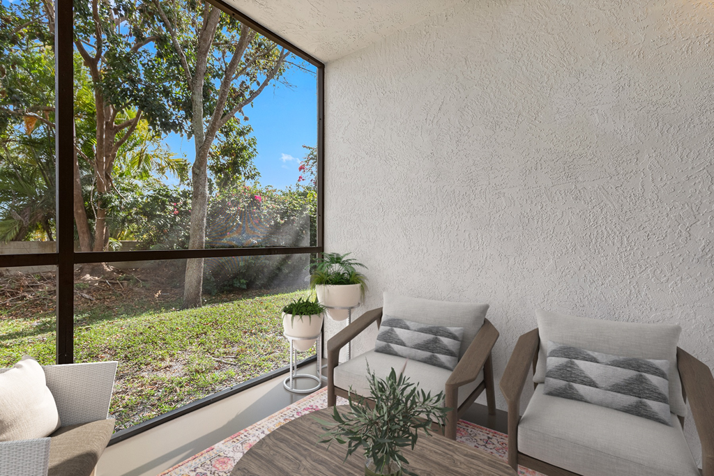 a living room with a large window and a table with two chairs