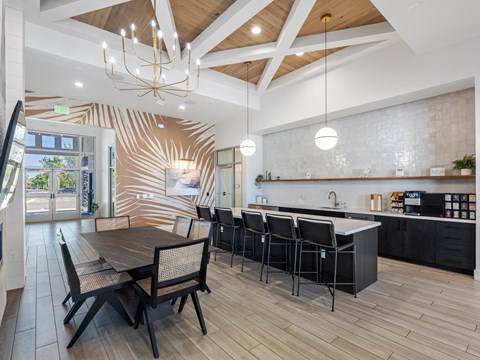 A modern kitchen with a dining table and chairs.