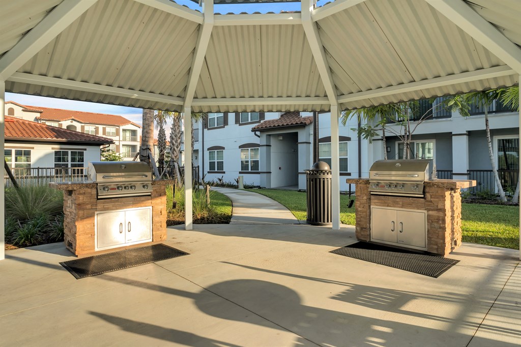 A covered walkway with two stone pillars and a sign that reads 00.